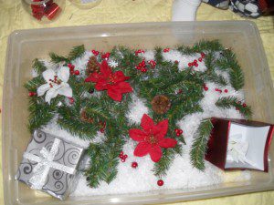 Christmas theme - fake snow, garland pieces, present boxes, small Christmas toys