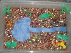 Dinosaur theme - beans, rocks, plastic dinosaurs and trees, felt river and lake