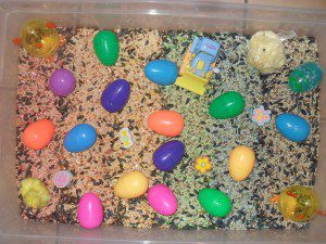 Easter theme - rainbow colored bird seed, plastic eggs, Easter erasers and little toys