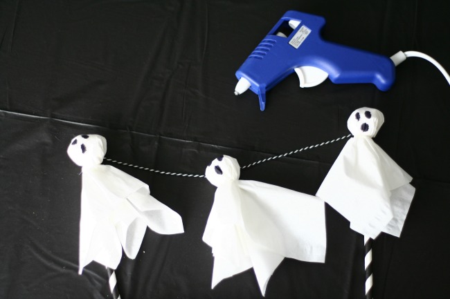 Glue ghosts to twine to create a hanging cake topper