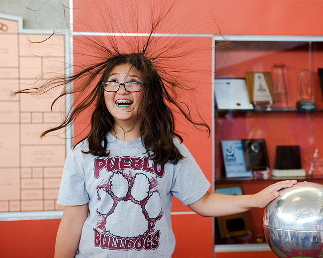 Caitlin Ang (12)of Peublo Elementary in Kyrene discovers why it isn't a good idea to put her hand on a Van de Graaff generator if she wants her hair to look just so.