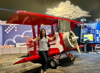 Lady standing in front of a pretend plane at the AZ Science Center
