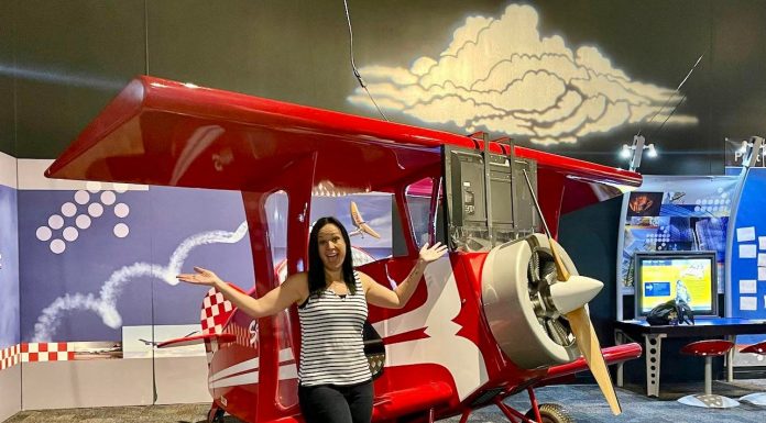 Lady standing in front of a pretend plane at the AZ Science Center